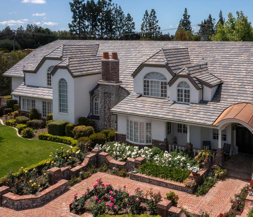 Eagle Roofing brochure photograph showing a tile roof on a landscaped home