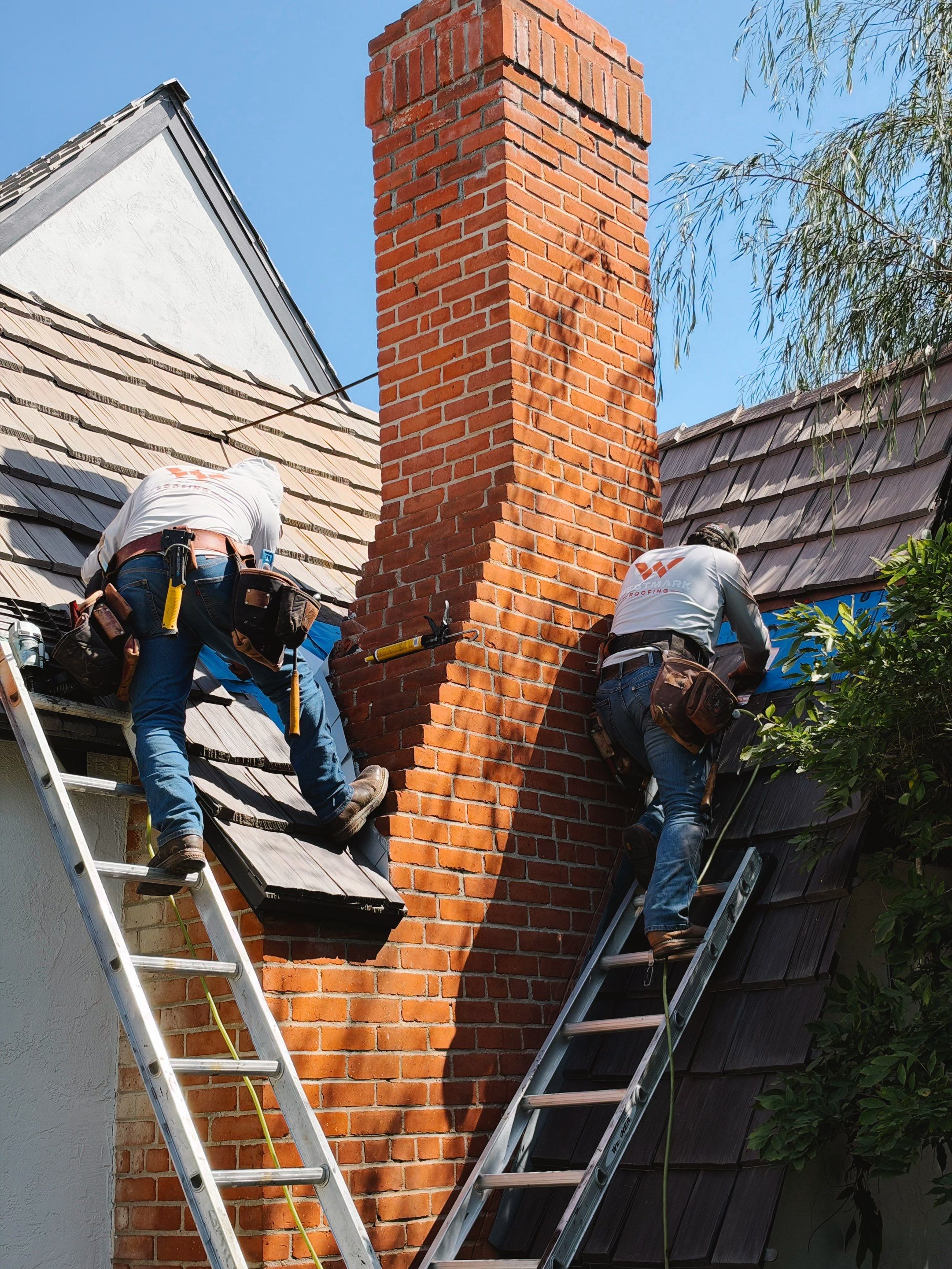 WESTMARK crew installing chimney flashing on a DaVinci roof in Ocean Beach, work in progress